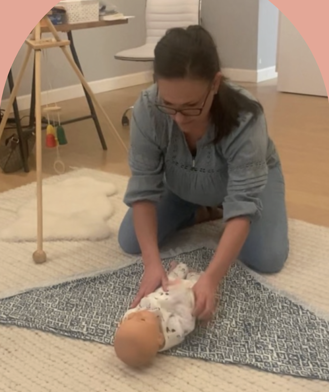 Mary demonstrating infant care techniques
